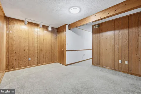 a view of a house with a wooden deck