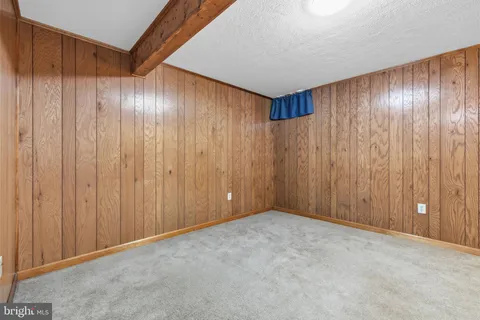 a view of a house with a wooden fence