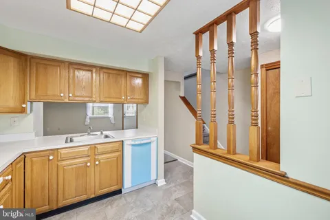 a kitchen with cabinets a sink and appliances