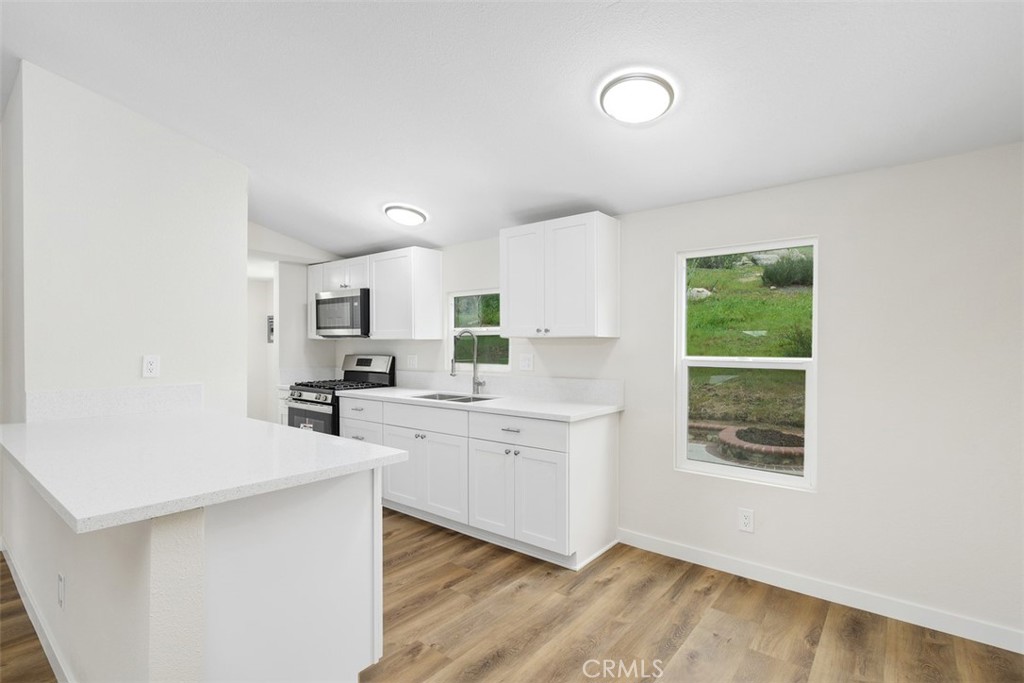 42580 East Benton Road Hemet, CA 92544 - Photo 13 of 31 a kitchen with white cabinets and sink