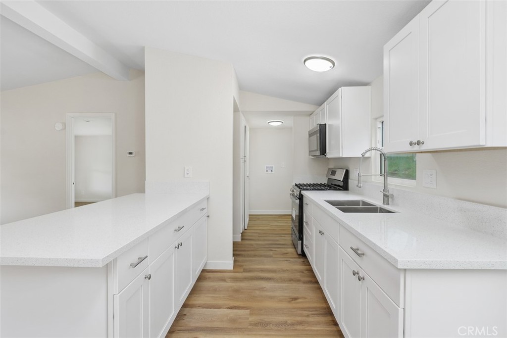 42580 East Benton Road Hemet, CA 92544 - Photo 14 of 31 a kitchen with white cabinets sink and stove