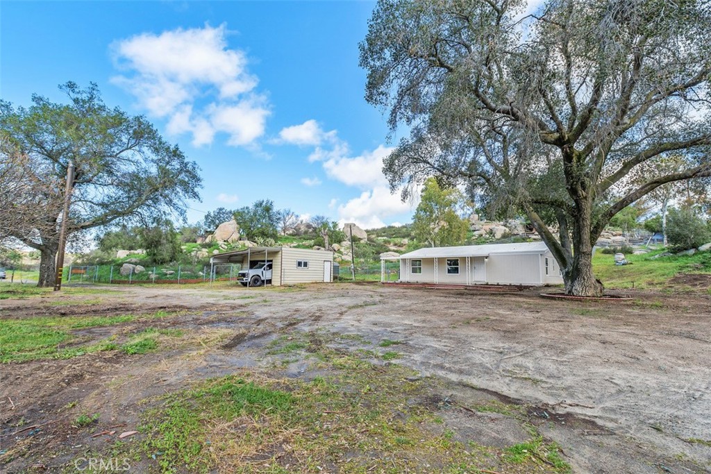 42580 East Benton Road Hemet, CA 92544 - Photo 2 of 31 a front view of a house with a yard and trees