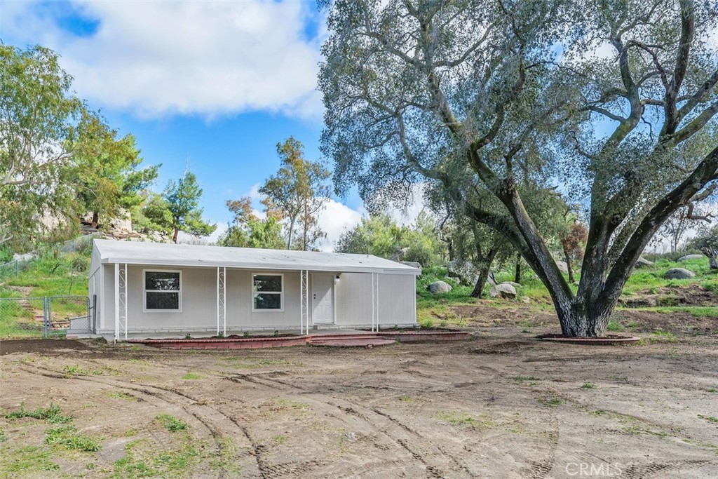 42580 East Benton Road Hemet, CA 92544 - Photo 5 of 31 front view of a house with a large trees and a big yard