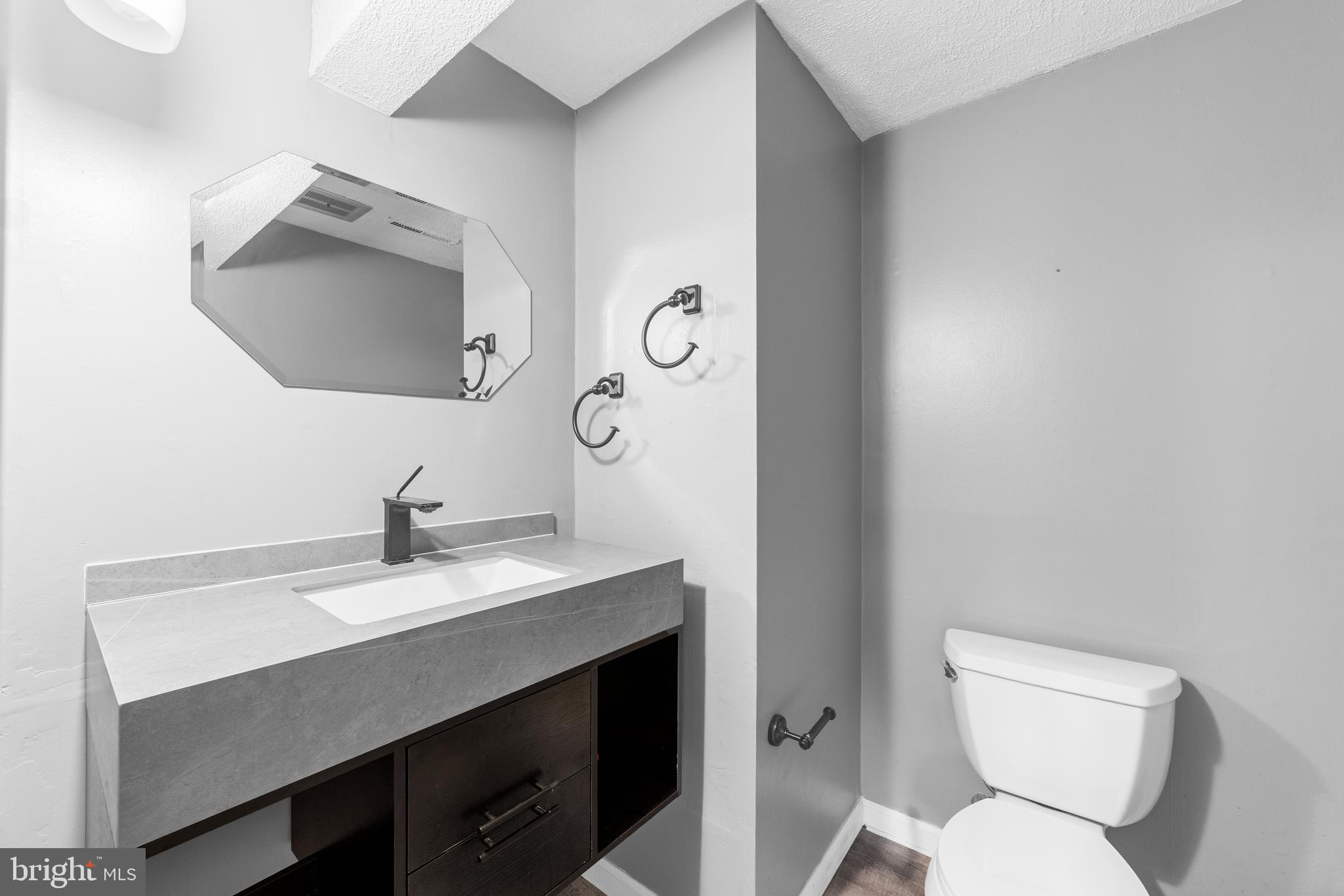 25 Clemson Road Cherry Hill, NJ 08034 - Photo 19 of 34 a bathroom with a toilet sink vanity and mirror