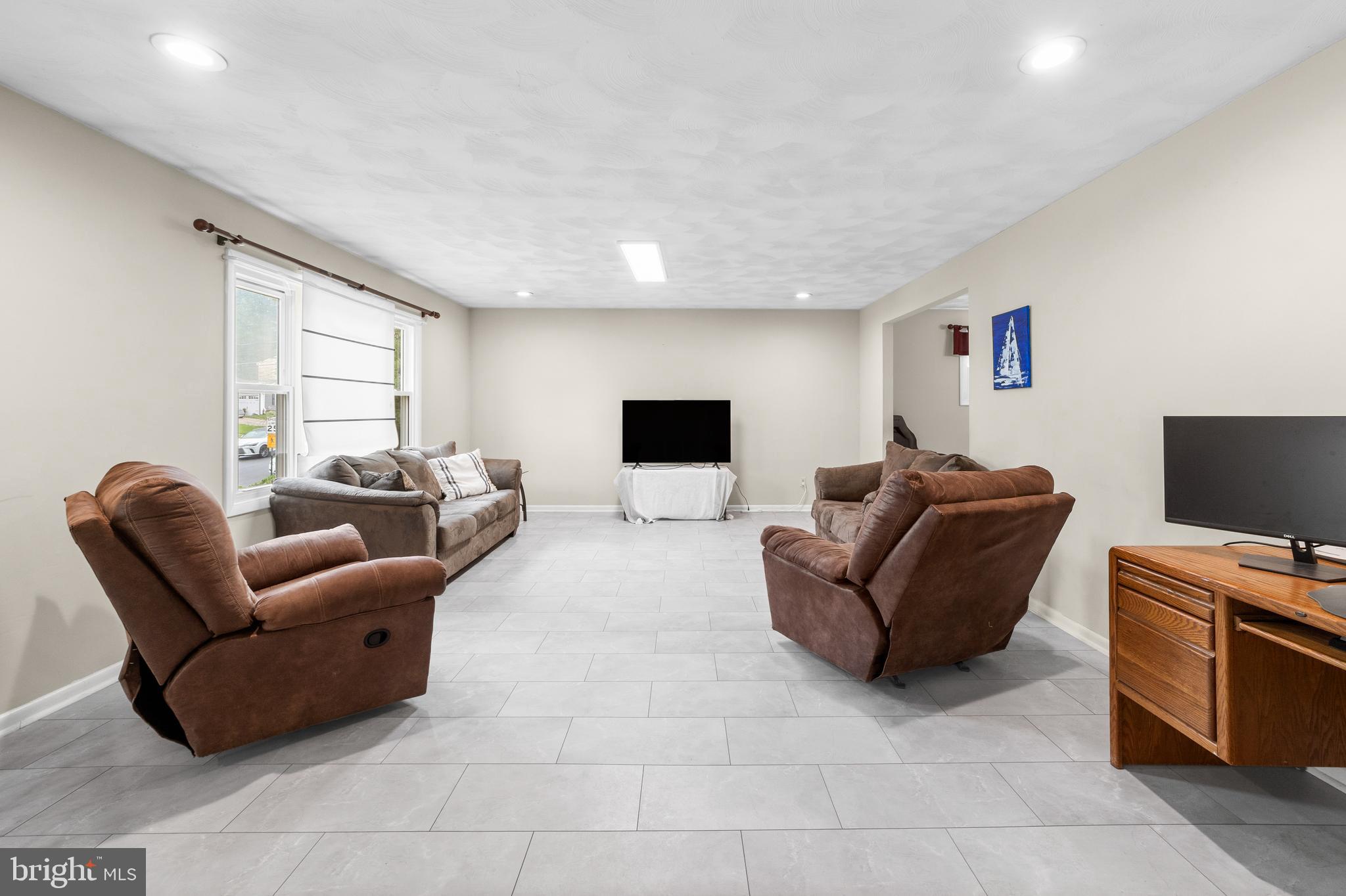 25 Clemson Road Cherry Hill, NJ 08034 - Photo 9 of 34 a living room with furniture a flat screen tv and a window