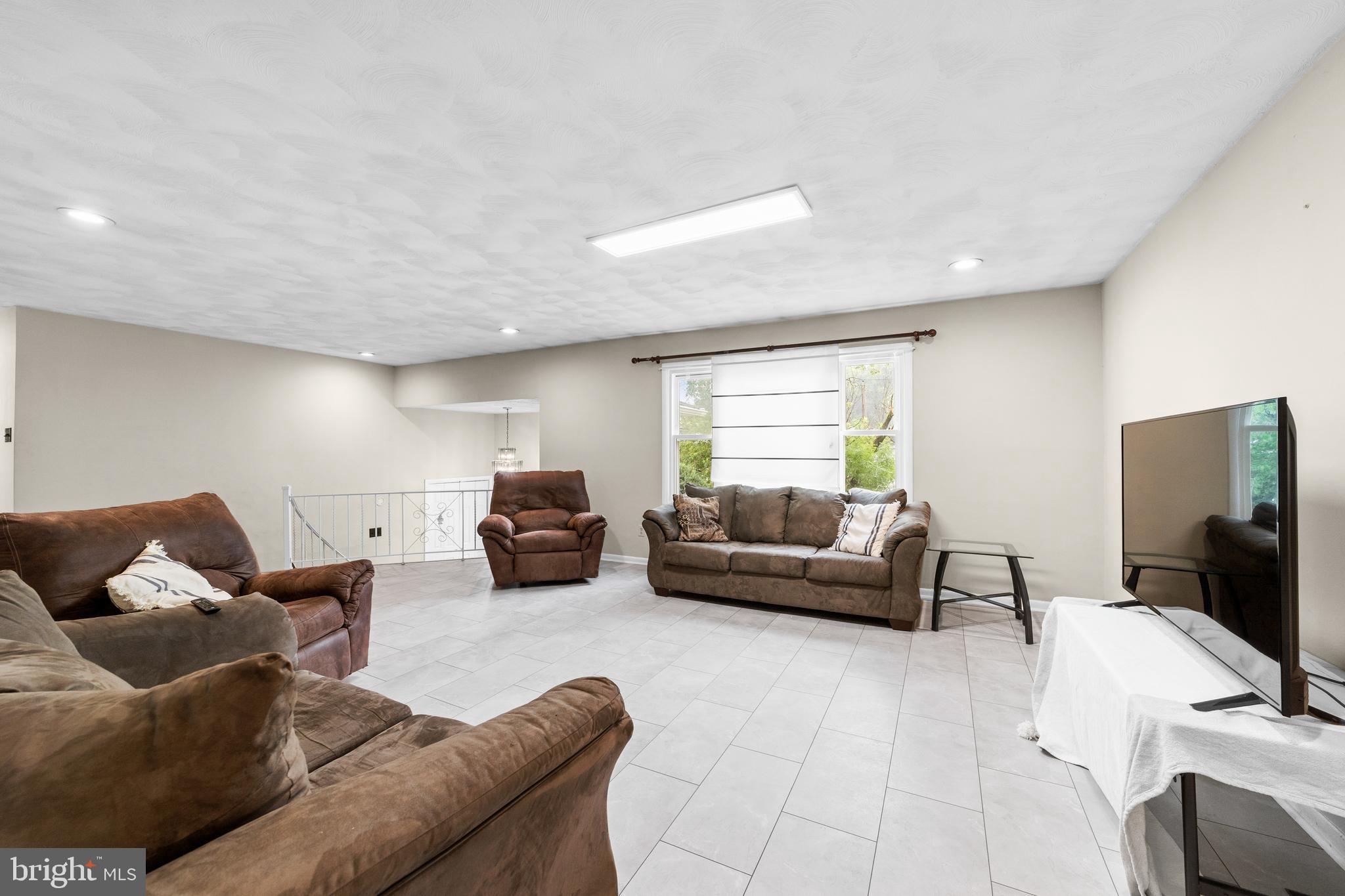 25 Clemson Road Cherry Hill, NJ 08034 - Photo 10 of 34 a living room with furniture and a flat screen tv