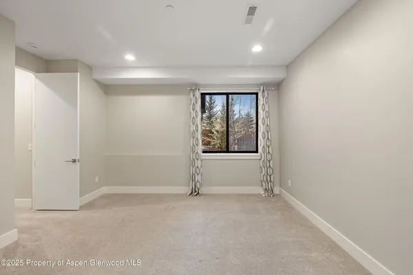 an empty room with windows and closet