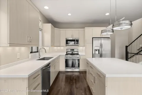 a kitchen with a sink a stove a refrigerator and a stove