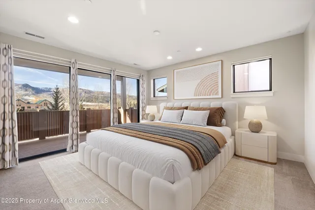 a bedroom with a large bed and a large window