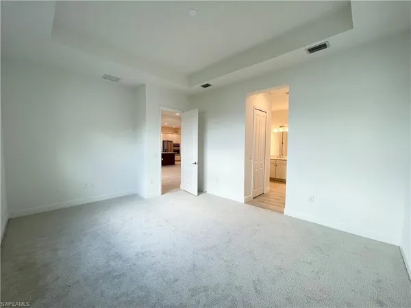 an empty room with windows and closet
