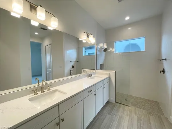 a bathroom with a double vanity sink and a mirror