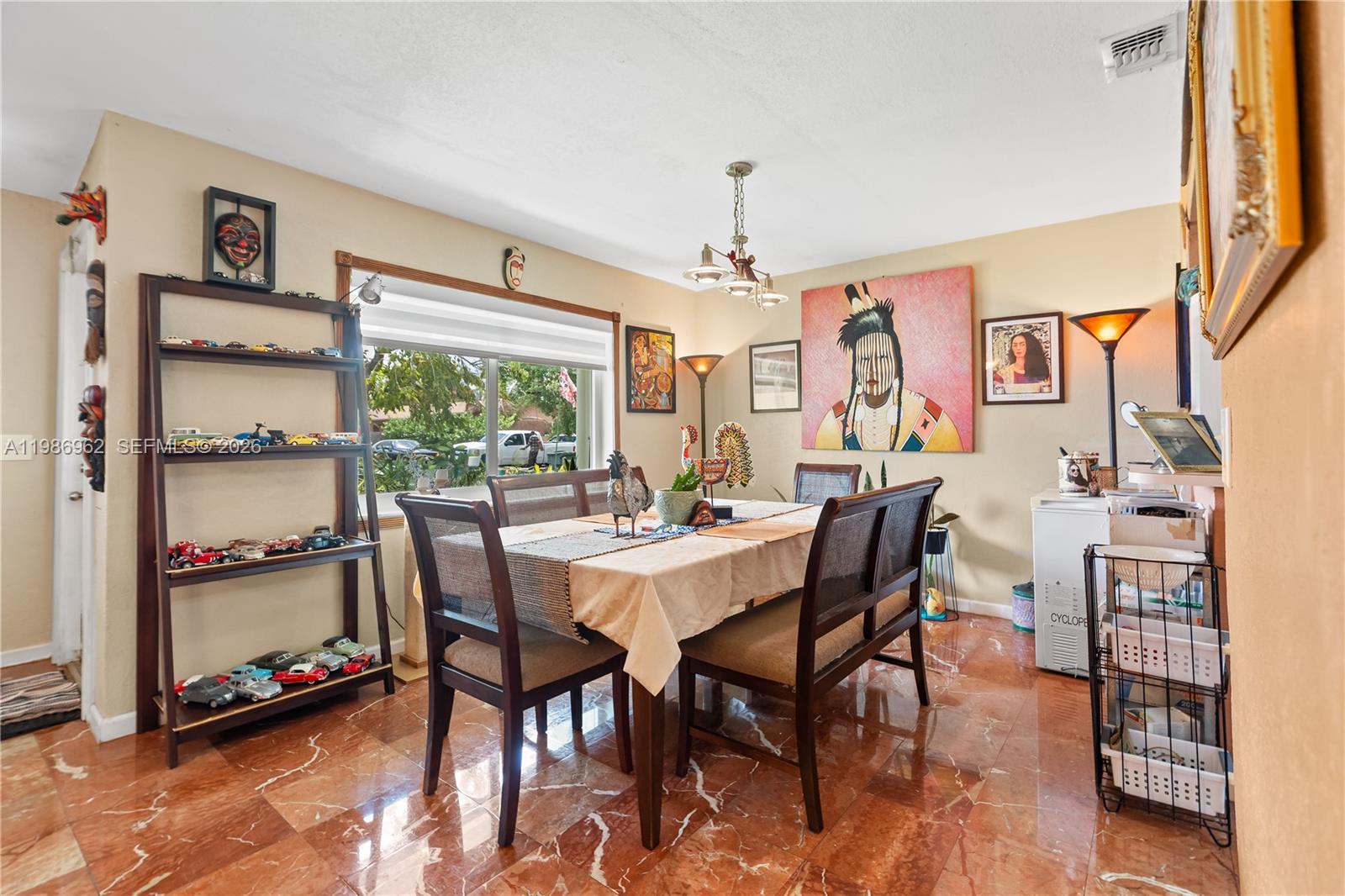 720 Northwest 4th Street Hallandale Beach, FL 33009 - Photo 13 of 27 a view of a dining room with furniture and a window