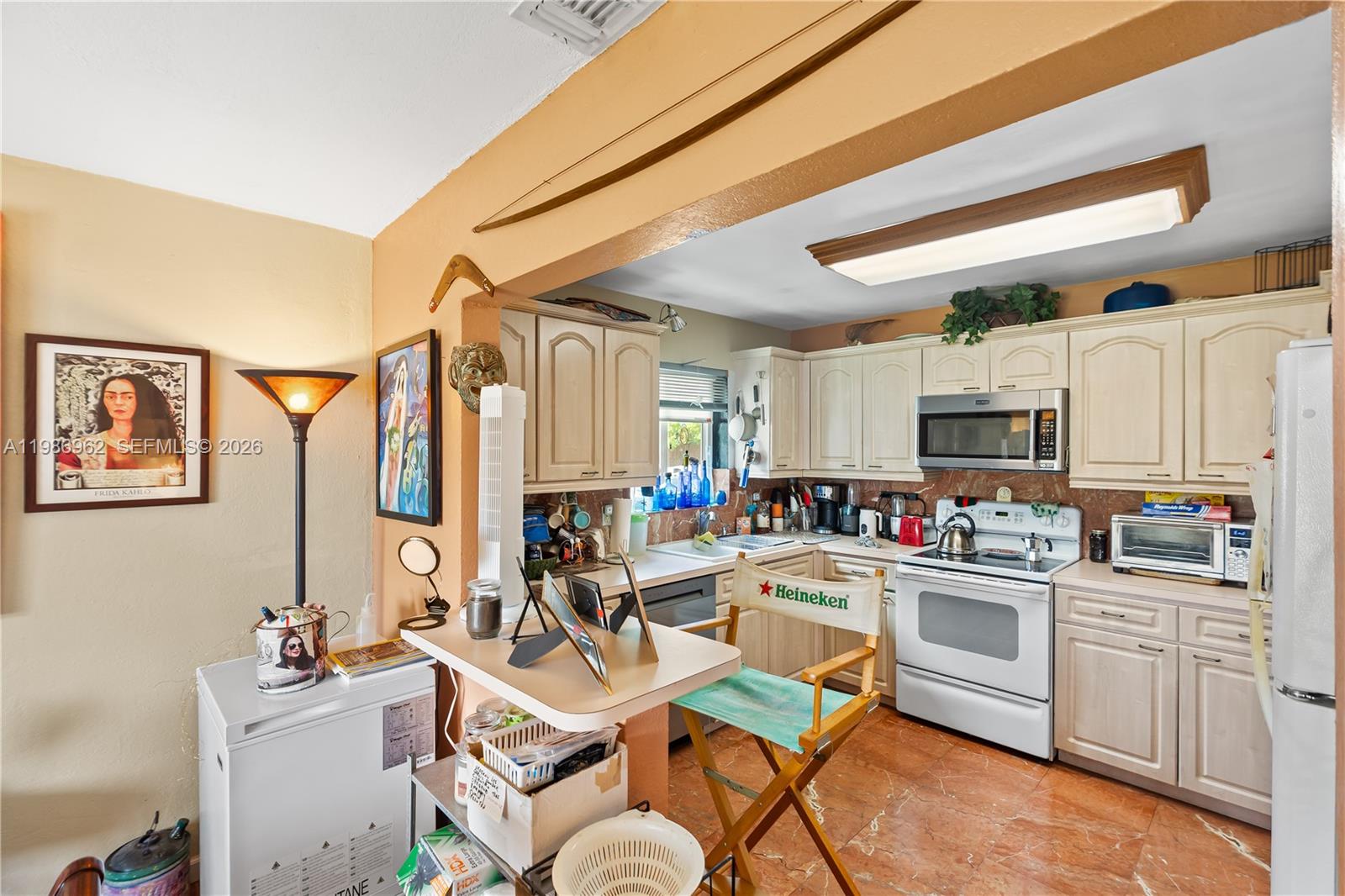 720 Northwest 4th Street Hallandale Beach, FL 33009 - Photo 15 of 27 a room with stainless steel appliances a sink and a refrigerator