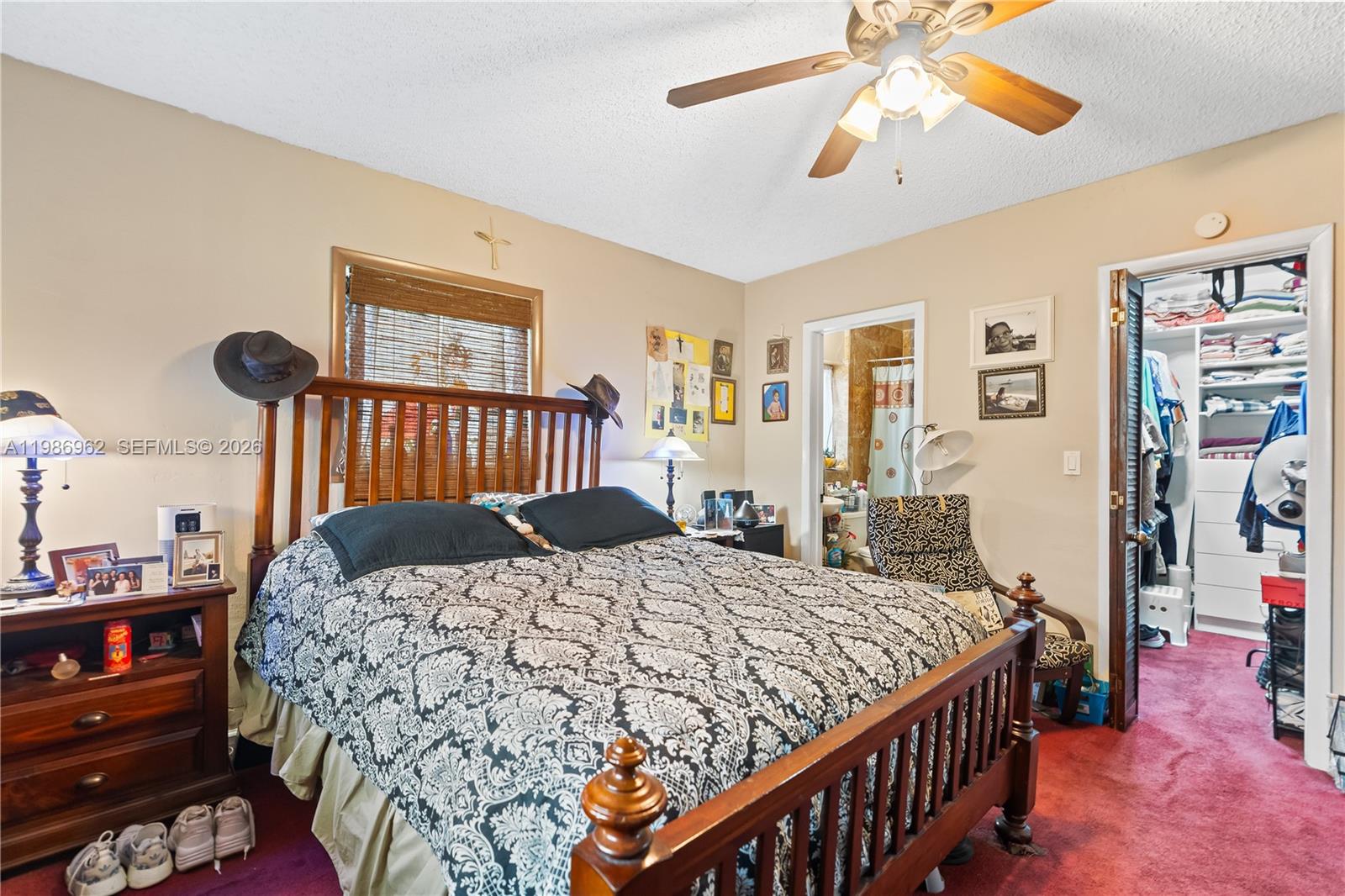 720 Northwest 4th Street Hallandale Beach, FL 33009 - Photo 19 of 27 a bedroom with a bed and a chandelier