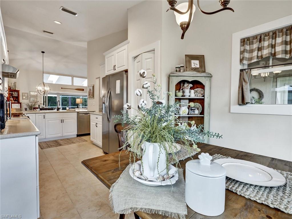 421 Countryside Drive Naples, FL 34104 - Photo 11 of 44 Dining space with a chandelier, recessed lighting, and a towering ceiling