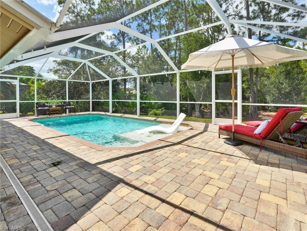 421 Countryside Drive Naples, FL 34104 - Photo 2 of 44 Outdoor pool with a lanai, a patio area, and a sunroom