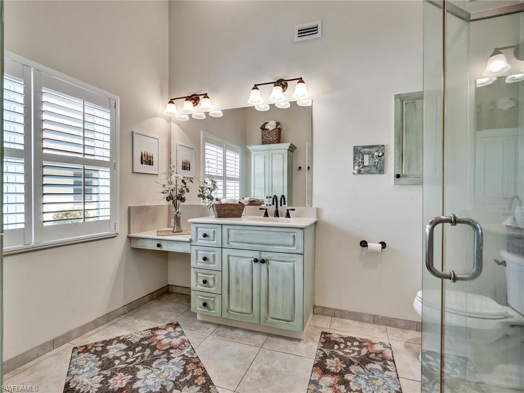 421 Countryside Drive Naples, FL 34104 - Photo 22 of 44 Full bathroom with vanity, a stall shower, and light tile patterned flooring