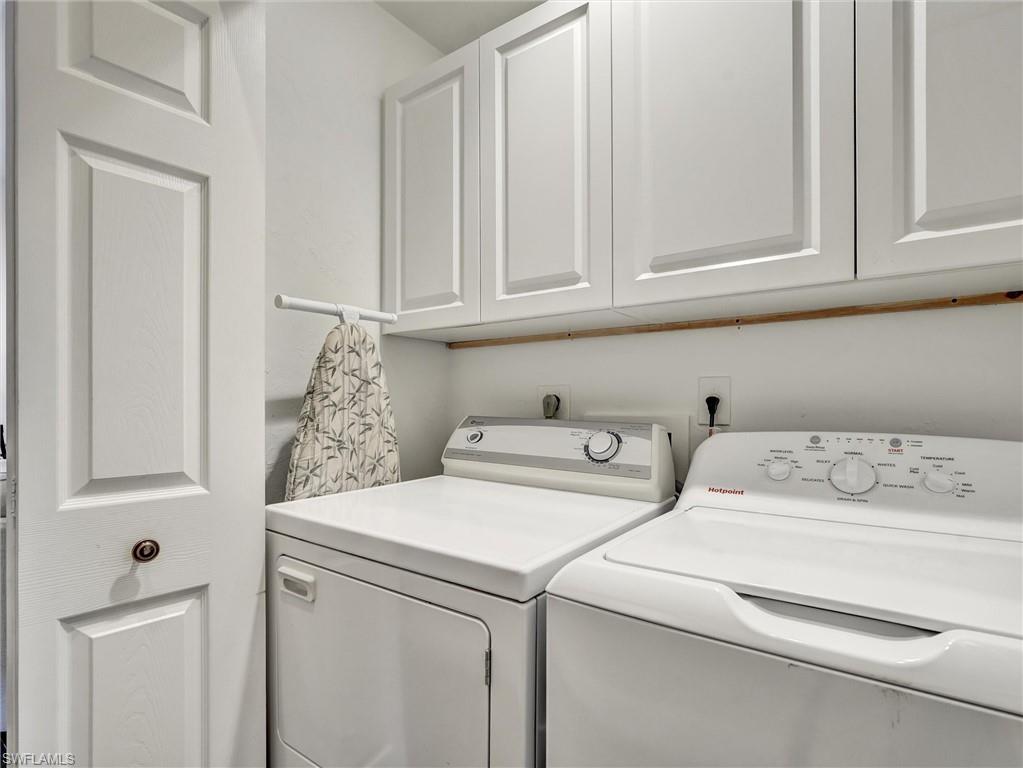 421 Countryside Drive Naples, FL 34104 - Photo 30 of 44 Laundry room with washing machine and clothes dryer and cabinet space