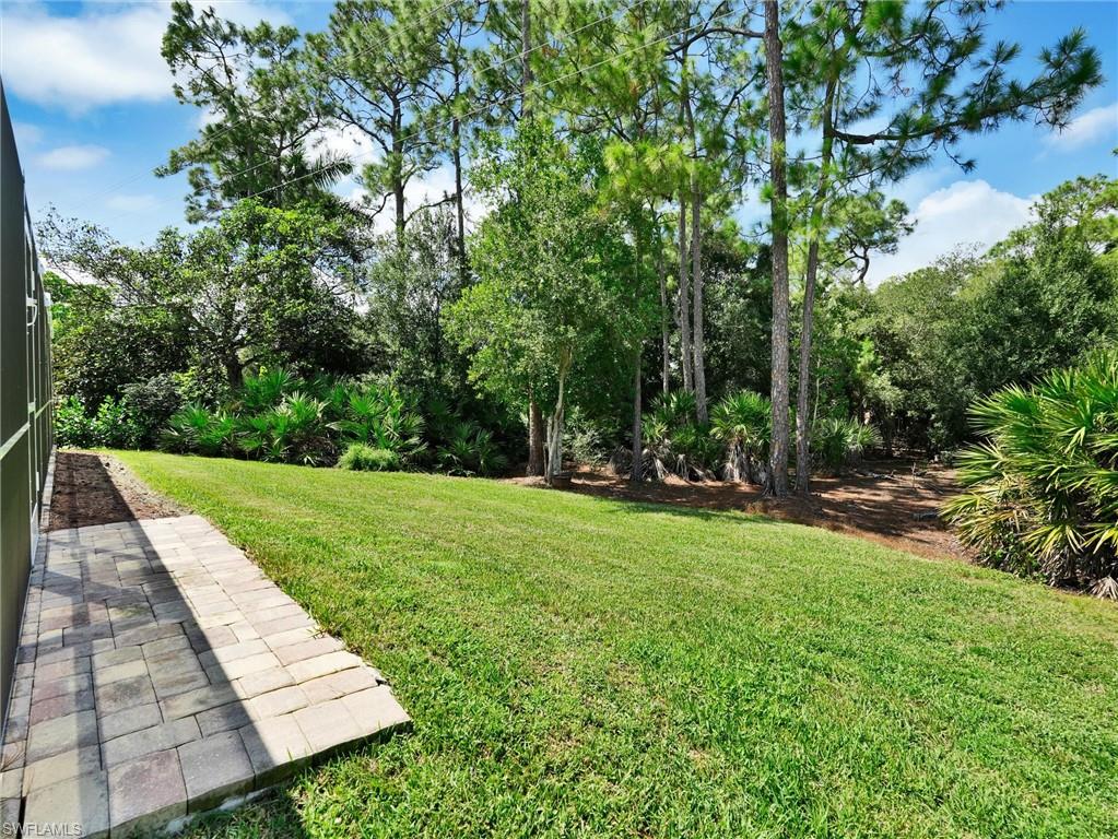 421 Countryside Drive Naples, FL 34104 - Photo 6 of 44 View of grassy yard with a patio area