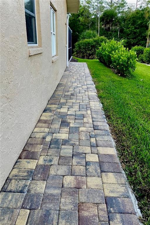 421 Countryside Drive Naples, FL 34104 - Photo 7 of 44 Paver walkway from front drive to rear of home.