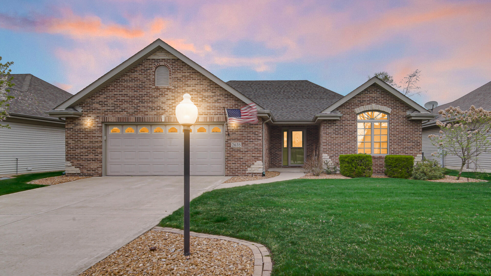 a front view of a house with a yard and garage