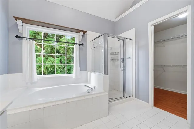 a bathroom with a bathtub and shower