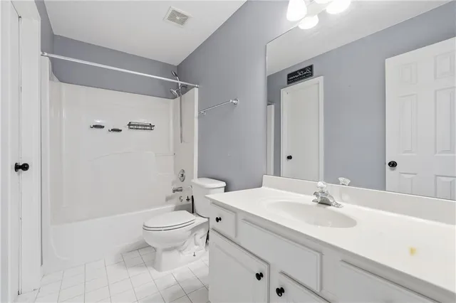 a bathroom with a sink toilet a mirror and shower