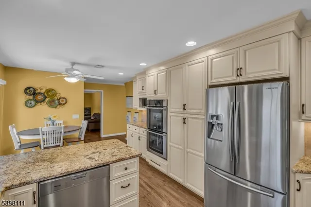 a kitchen with stainless steel appliances granite countertop a refrigerator and a sink