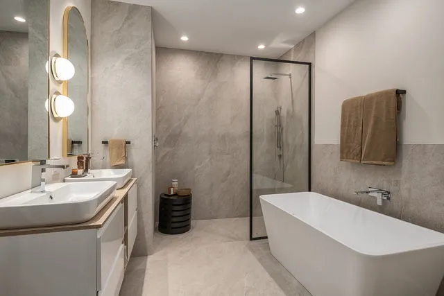 a bathroom with a tub a sink and mirror