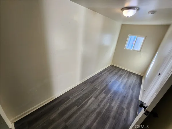 a view of an empty room and wooden floor
