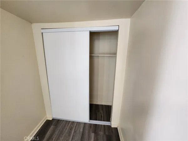 a view of walk in closet with wooden floor