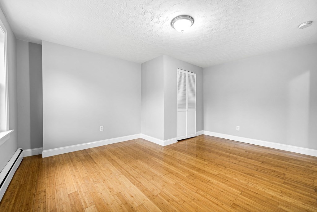 19 Forest Drive Auburn, MA 01501 - Photo 13 of 31 an empty room with wooden floor and windows