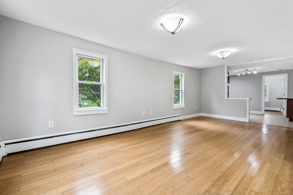 19 Forest Drive Auburn, MA 01501 - Photo 16 of 31 an empty room with wooden floor and windows