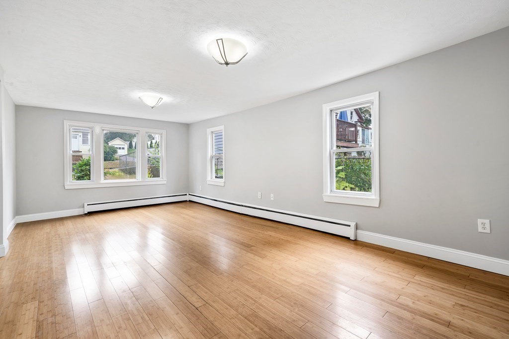 19 Forest Drive Auburn, MA 01501 - Photo 18 of 31 an empty room with wooden floor and windows