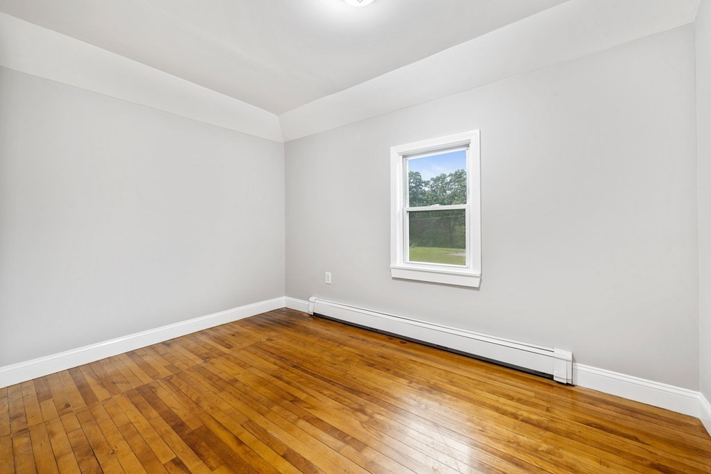 19 Forest Drive Auburn, MA 01501 - Photo 19 of 31 an empty room with wooden floor and a window
