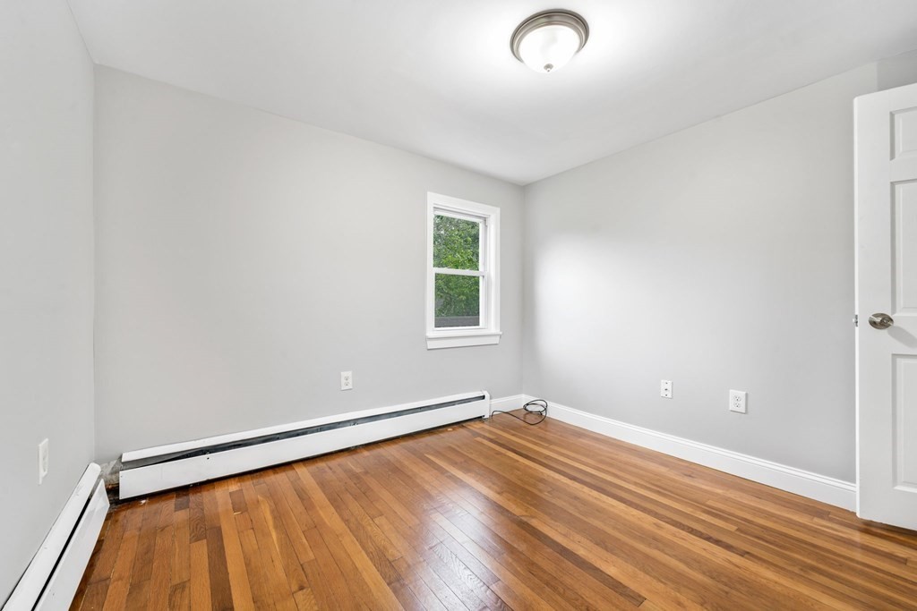 19 Forest Drive Auburn, MA 01501 - Photo 22 of 31 an empty room with wooden floor and windows