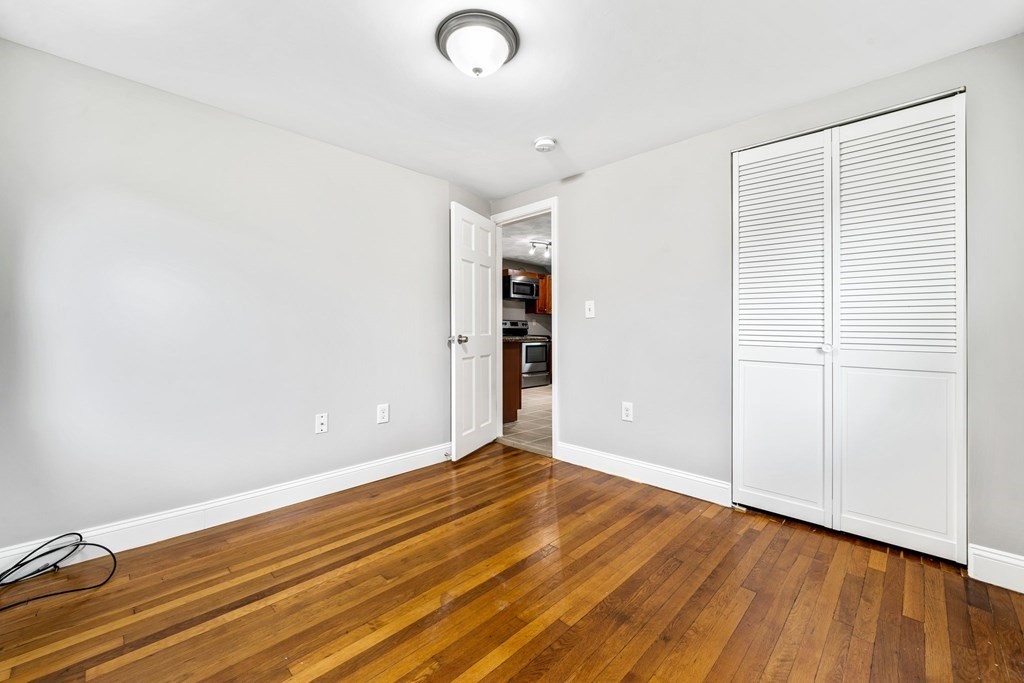19 Forest Drive Auburn, MA 01501 - Photo 23 of 31 an empty room with wooden floor and closet