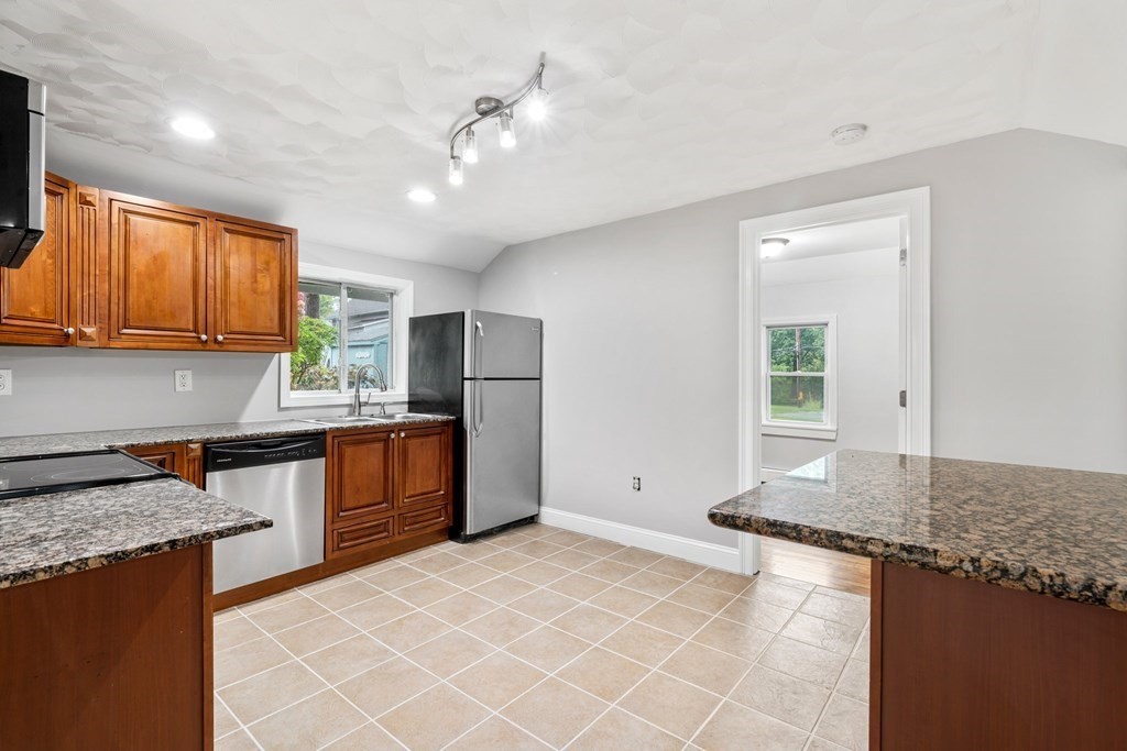 19 Forest Drive Auburn, MA 01501 - Photo 8 of 31 a kitchen with stainless steel appliances granite countertop a sink stove and refrigerator