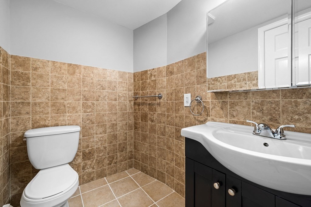 19 Forest Drive Auburn, MA 01501 - Photo 9 of 31 a bathroom with a toilet a sink and mirror