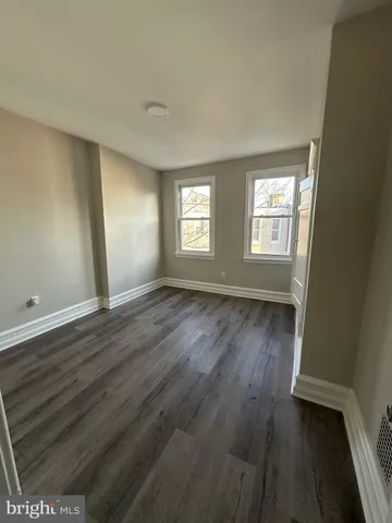 a view of wooden floor and windows in a room