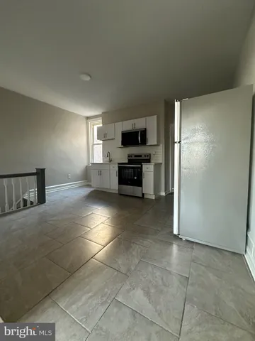 a kitchen with stainless steel appliances a refrigerator and a stove top oven