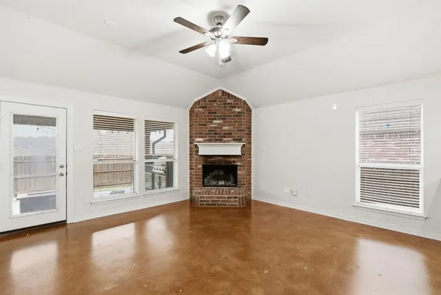 a view of a kitchen with cabinets and wooden floor