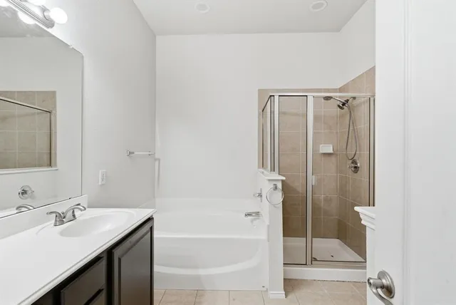 a bathroom with a granite countertop sink a toilet and shower