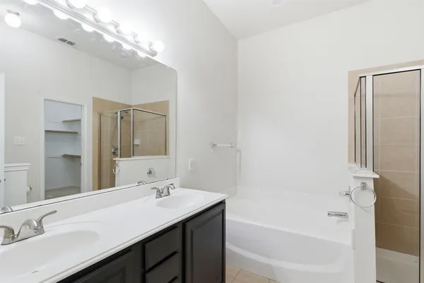 a bathroom with a bathtub and a shower