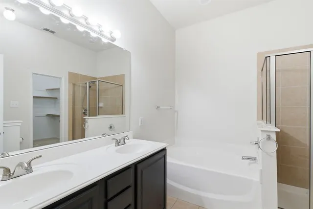 a bathroom with a bathtub and a shower