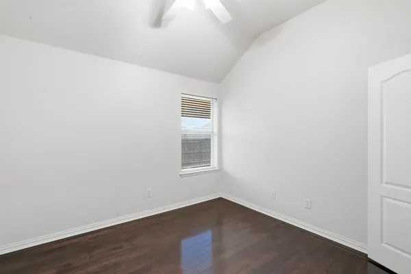 an empty room with wooden floor
