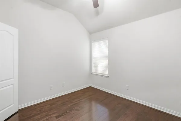 an empty room with wooden floor