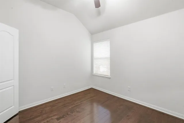 an empty room with wooden floor