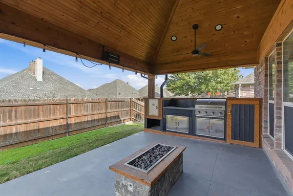 a view of a backyard with wooden fence