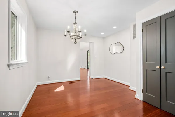 a view of a room with wooden floor and chandelier